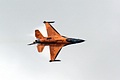 With condensation being squeezed from its uppersurfaces the Royal Netherlands Air Force Solo Display F-16AM pulls round hard