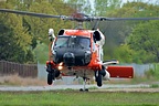 U.S. Coast Guard M-60J Jay Hawk touching down in the grass