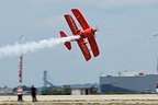 Sean D. Tucker cutting the ribbon with his Oracle Challenger