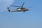 Fight engineer operates the hoist device to simulate a personnel recovery. The HH-60G rescue equipment includes a hoist capable of lifting a 270 kilograms load (600 pound) from a hover height of 60.7 meters (200 feet)