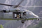 Flight engineer on board the HH-60G simulates a personnel recovery operation with hoist