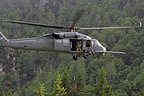 Flight engineer on board the HH-60G operating the hoist capable of lifting a 270 kilograms load (600 pound) from a hover height of 60.7 meters (200 feet)