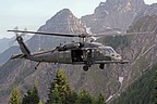 The 56th RQS HH-60G approaching to landing point, in the background the Alpine mountains