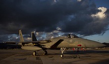 RSAF F-15C Eagle 215 in the evening sun with the thunderstorm clouds overhead