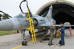 Colonel Athanasios Ganas handing off his helmet to he could pose for a picture