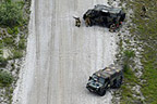 The ground seek cover behind their VM 90 vehicle as threat level rises