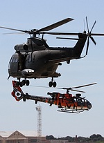 RAF Puma HC.2 with the 3 RHC Gazelle in tiger colors in the background